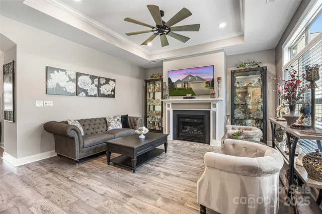 a living room with furniture a flat screen tv and a fireplace
