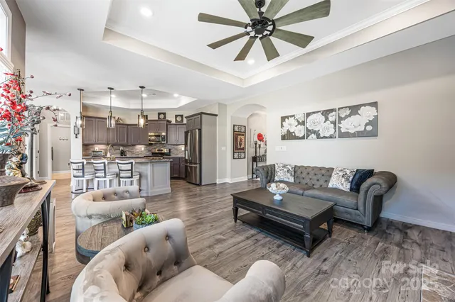 a living room with furniture and kitchen view