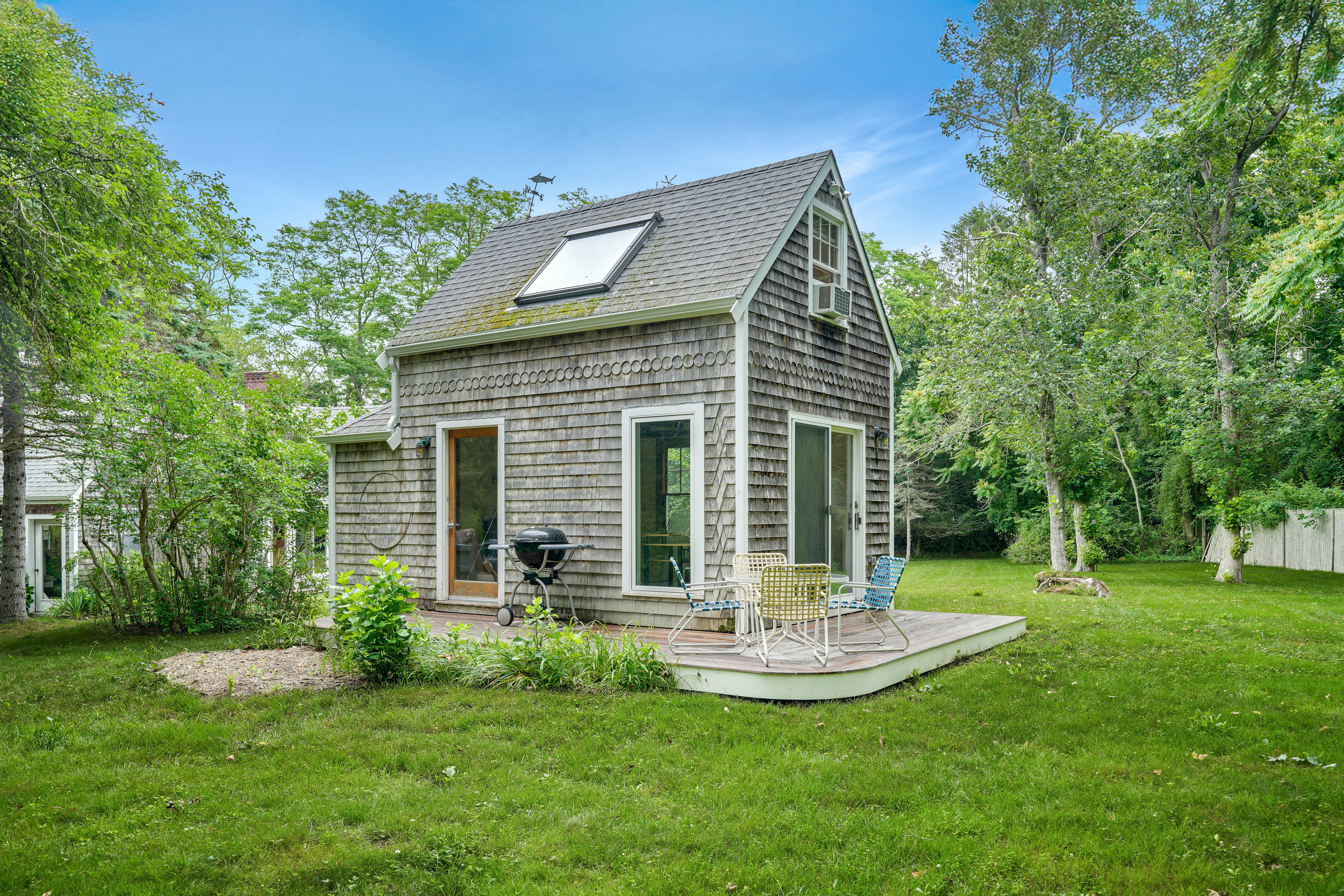 174 Middle Road Chilmark, MA 02535 - Photo 29 of 40 a view of a house with a yard and sitting area