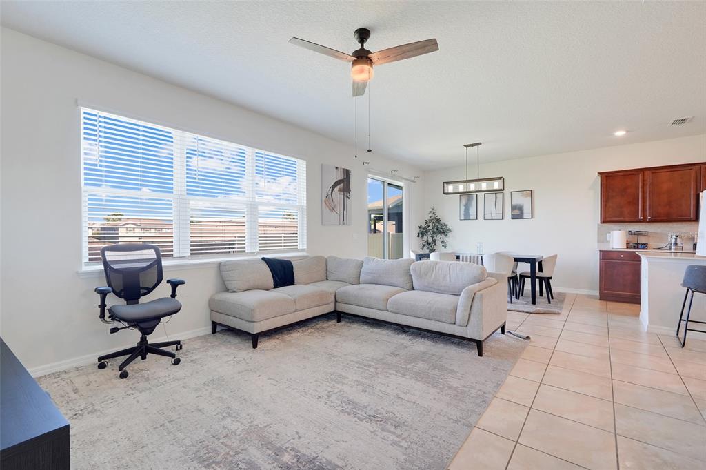 2611 Hilltop Loop Apopka, FL 32712 - Photo 20 of 46 a living room with furniture and a flat screen tv