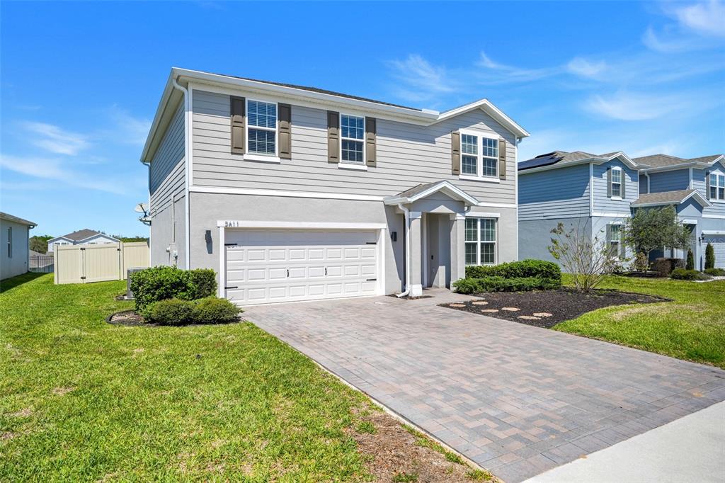2611 Hilltop Loop Apopka, FL 32712 - Photo 2 of 46 a front view of a house with a yard
