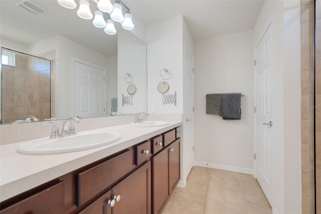 2611 Hilltop Loop Apopka, FL 32712 - Photo 23 of 46 a bathroom with a sink a light fixture and a mirror