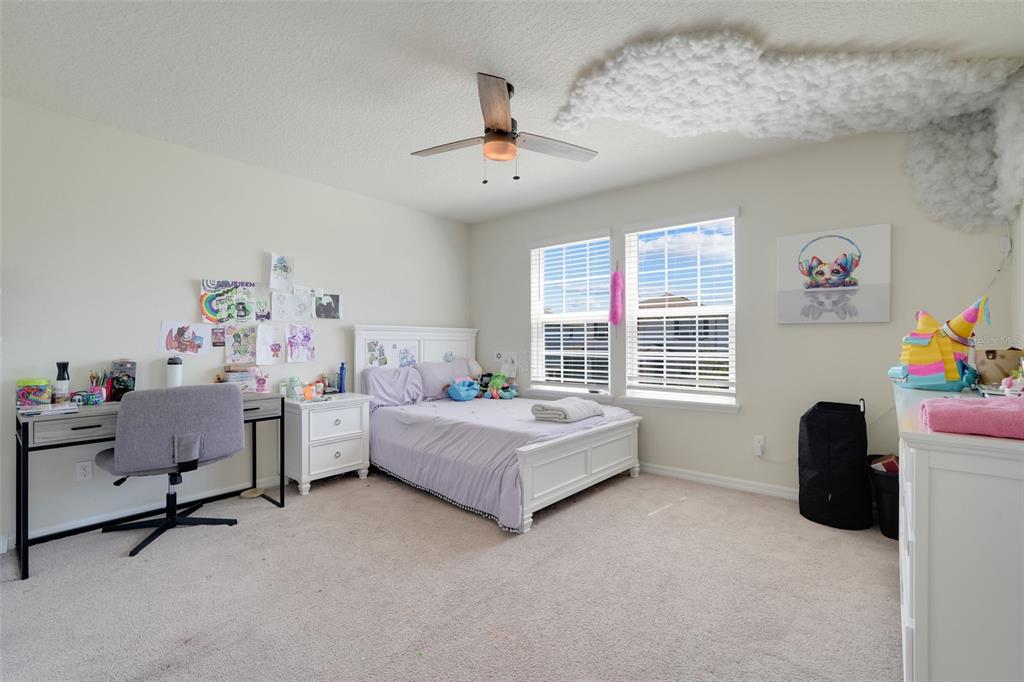 2611 Hilltop Loop Apopka, FL 32712 - Photo 24 of 46 a bedroom with furniture and a large window