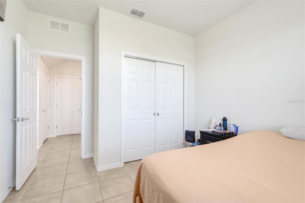 2611 Hilltop Loop Apopka, FL 32712 - Photo 25 of 46 a bedroom with a bed and a closet