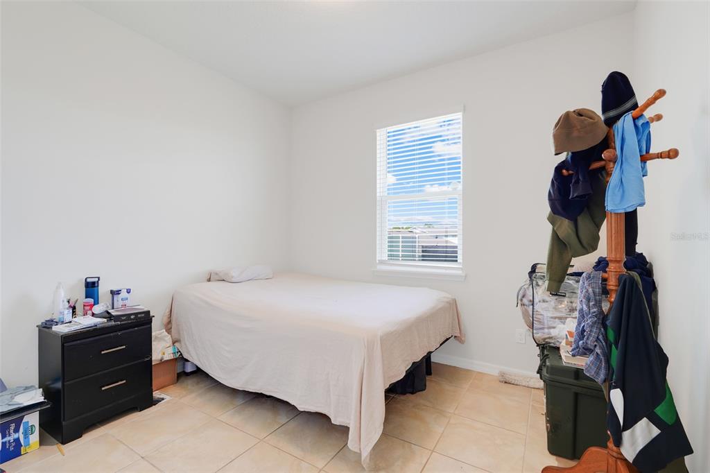 2611 Hilltop Loop Apopka, FL 32712 - Photo 26 of 46 a bedroom with a bed and a window