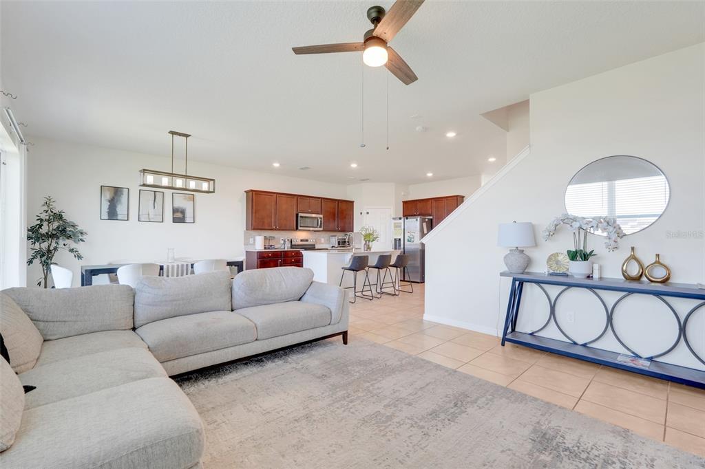 2611 Hilltop Loop Apopka, FL 32712 - Photo 27 of 46 a living room with furniture a rug and a chandelier