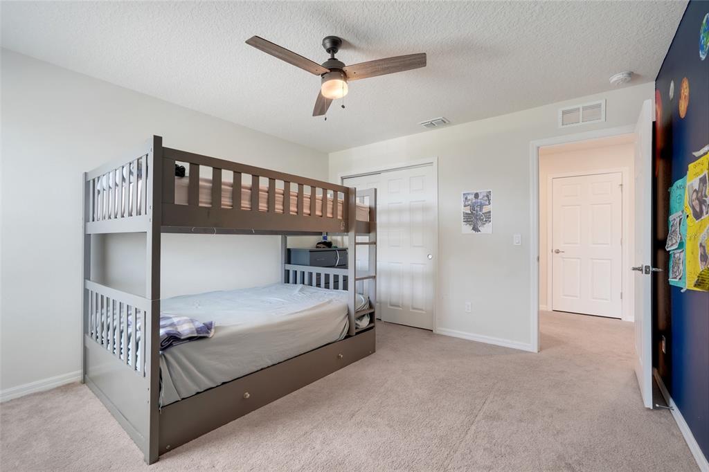 2611 Hilltop Loop Apopka, FL 32712 - Photo 28 of 46 a bedroom with a bed and a chandelier