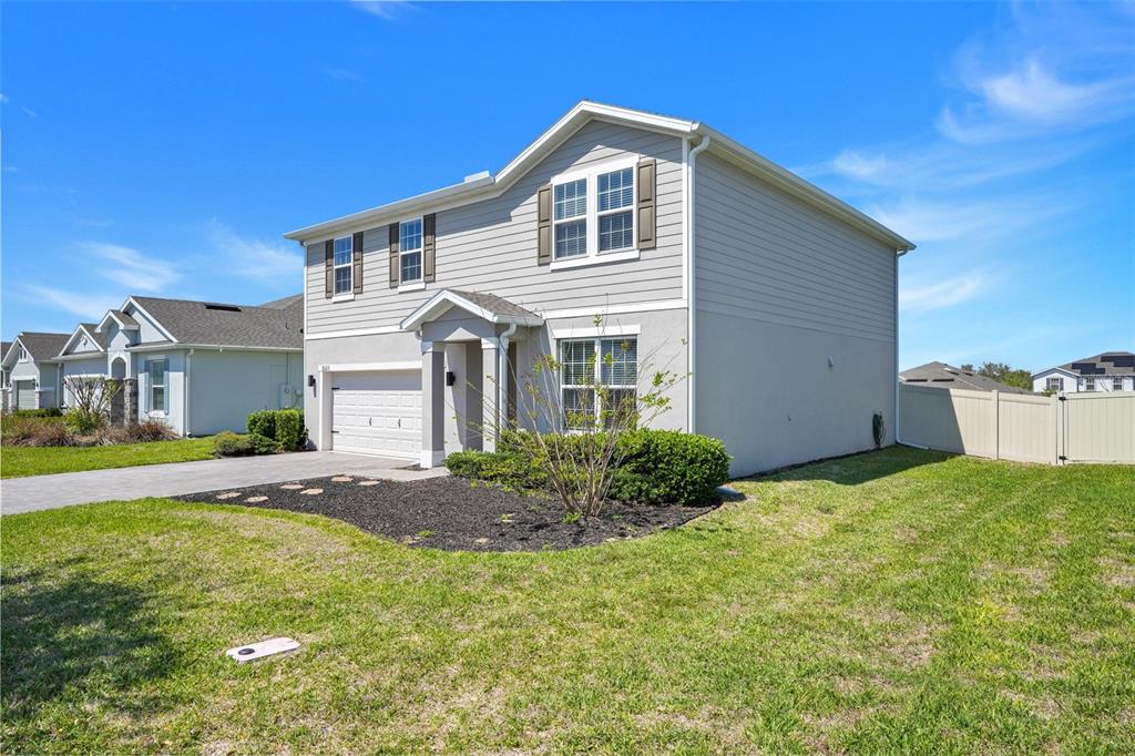 2611 Hilltop Loop Apopka, FL 32712 - Photo 3 of 46 a front view of a house with a garden