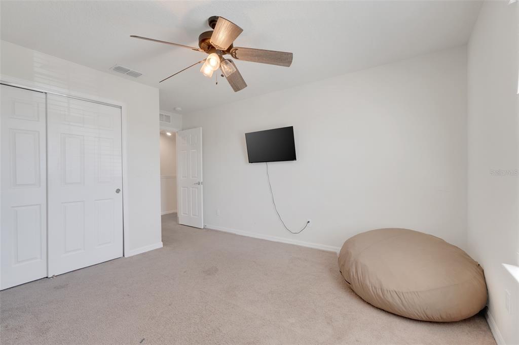 2611 Hilltop Loop Apopka, FL 32712 - Photo 32 of 46 a view of a room with a ceiling fan and wooden floor