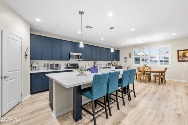 a large kitchen with a table and chairs