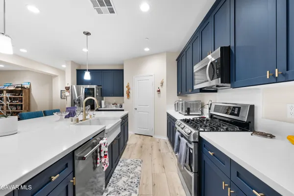a kitchen with a sink stove and microwave