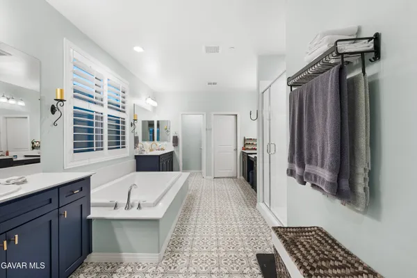 a large white kitchen with a sink and dishwasher with wooden floor