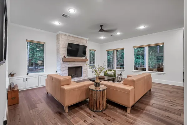 a living room with furniture and a wooden floor