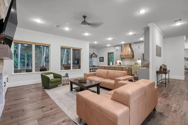 a living room with fireplace furniture and a flat screen tv