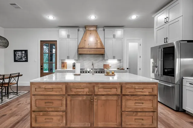 a kitchen with sink cabinets and refrigerator