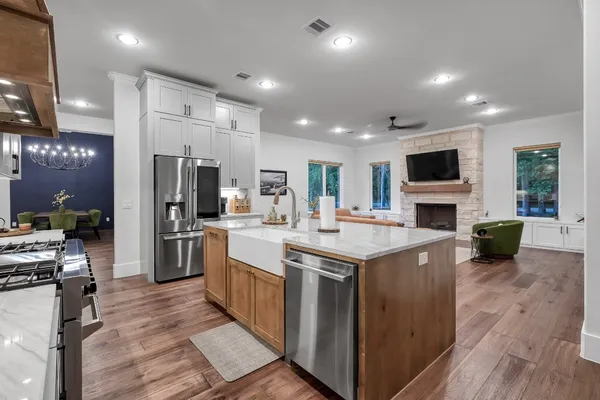 a kitchen with kitchen island white cabinets and stainless steel appliances