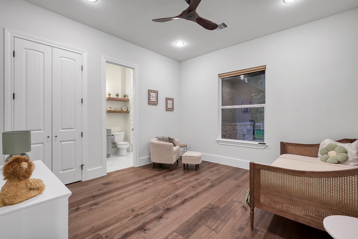 15937 Stagecoach Road Stagecoach, TX 77355 - Photo 25 of 50 a bedroom with a bed and wooden floor