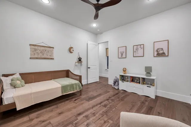 a bedroom with a bed and wooden floor