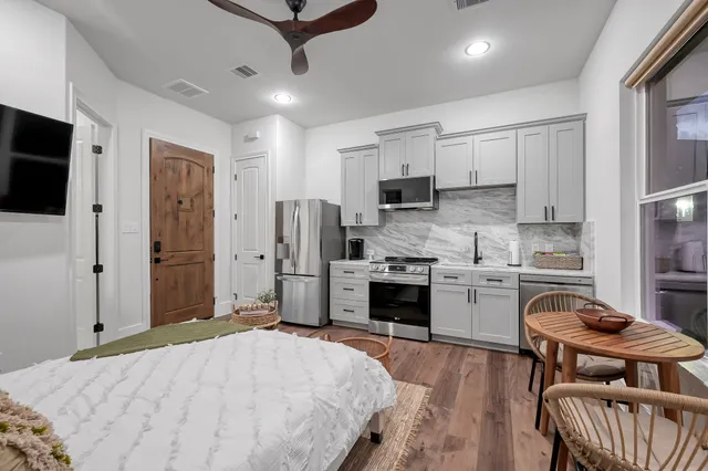 a bedroom with furniture and a flat screen tv