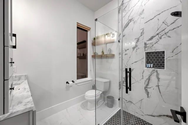 a kitchen with stainless steel appliances a refrigerator stove microwave and cabinets