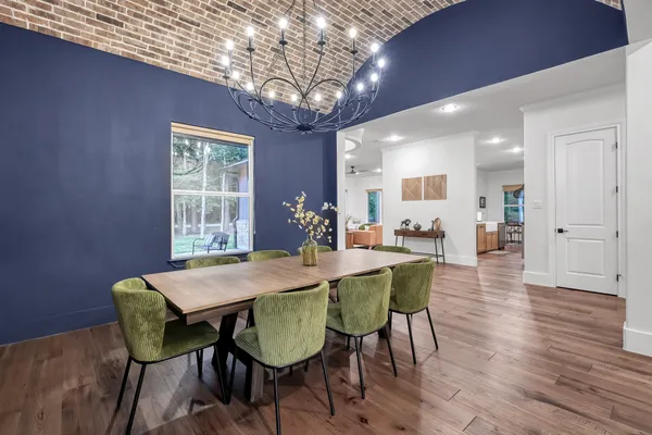 a dining room with furniture and wooden floor