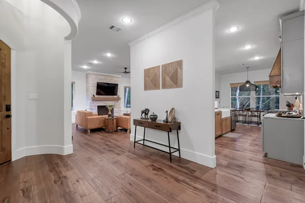 a view of a garden with a fountain and large trees