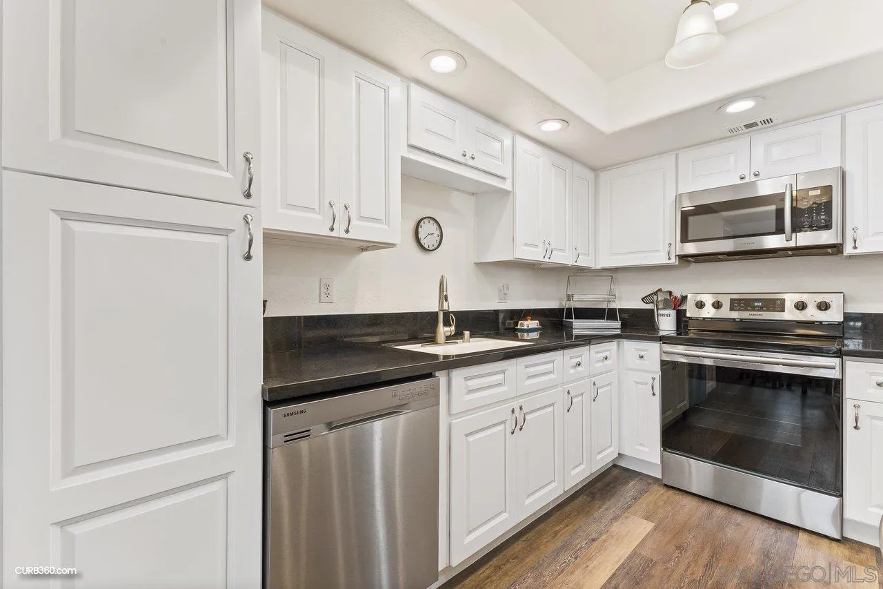 13967 Midland Road Poway, CA 92064 - Photo 8 of 37 a kitchen with stainless steel appliances granite countertop a sink and a microwave