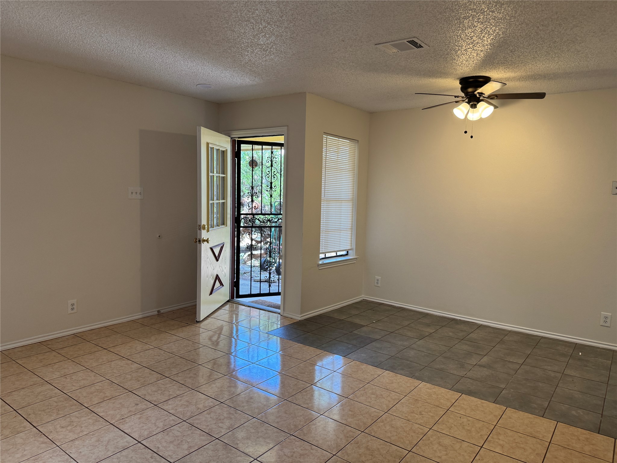 12503 Turtle Rock Road, Unit B Austin, TX 78729 - Photo 13 of 17 an empty room with windows and fan