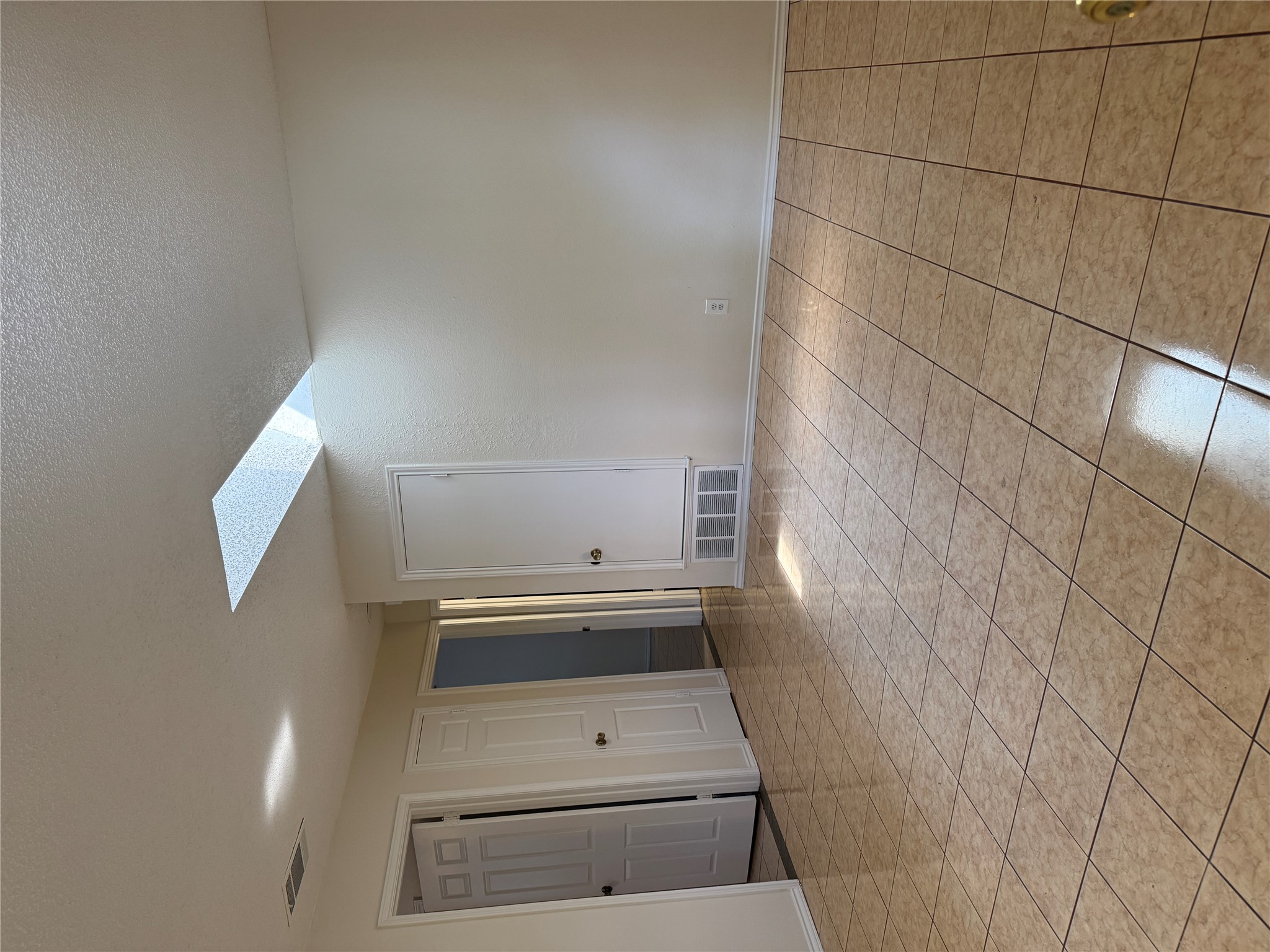 12503 Turtle Rock Road, Unit B Austin, TX 78729 - Photo 3 of 17 a view of an empty room and window