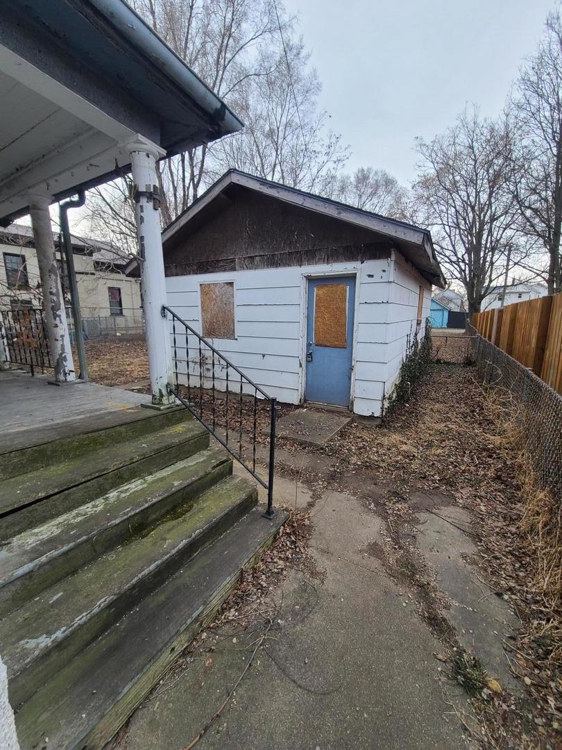 369 South 4th Avenue Kankakee, IL 60901 - Photo 2 of 15 a view of backyard with wooden fence and large trees