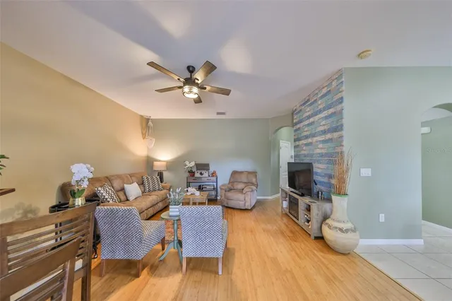 a living room with furniture and kitchen view