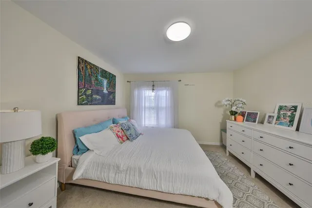 a spacious bedroom with a bed and a table