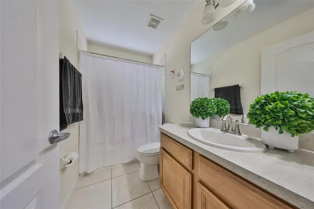 a view of a patio with table and chairs potted plants