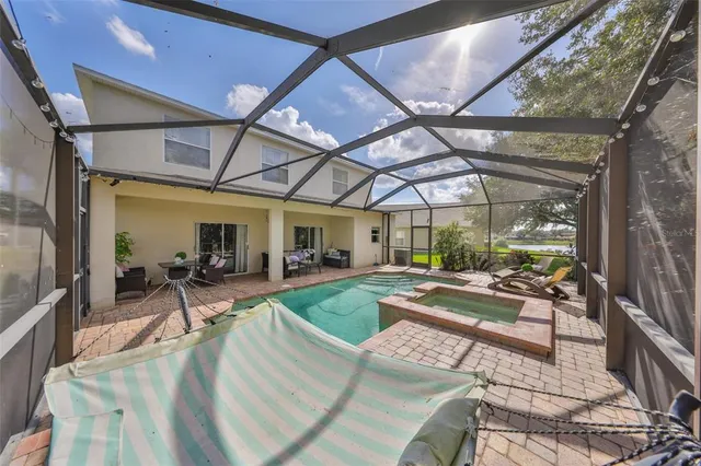 an aerial view of residential houses with outdoor space and lake view