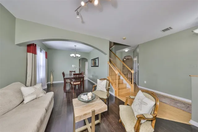 a dining room with furniture and wooden floor