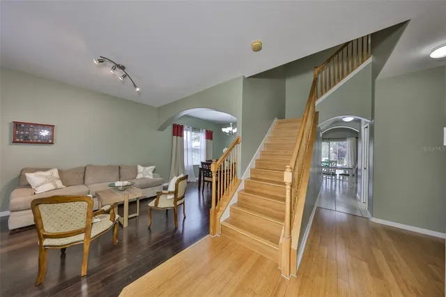 a view of a dining room with furniture wooden floor and chandelier
