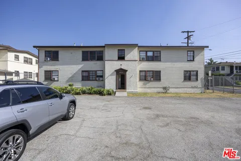 a front view of a house with parking space