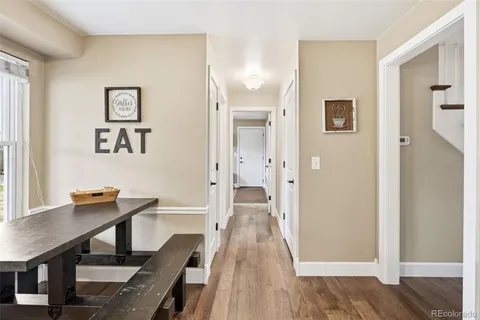 a view of a dining room with furniture and wooden floor
