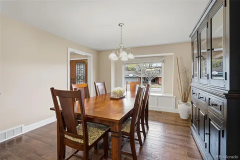 a view of a dining room with furniture window and wooden floor