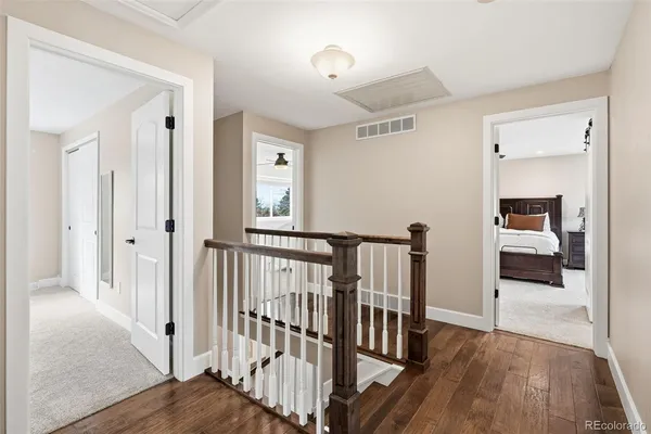 a view of a hallway with a hardwood floor and a livingroom