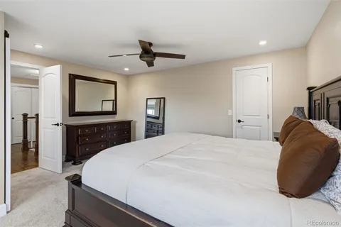 a bedroom with a bed and a large mirror