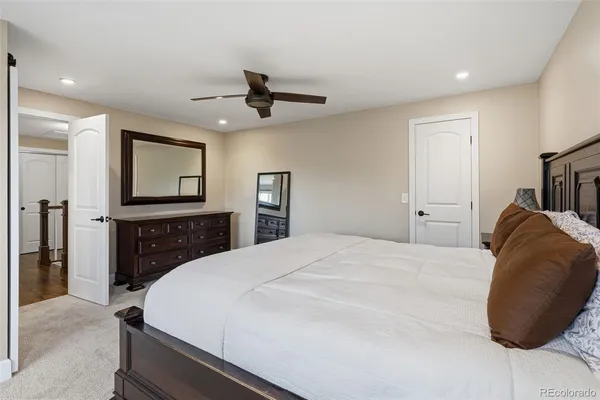 a bedroom with a bed and a large mirror