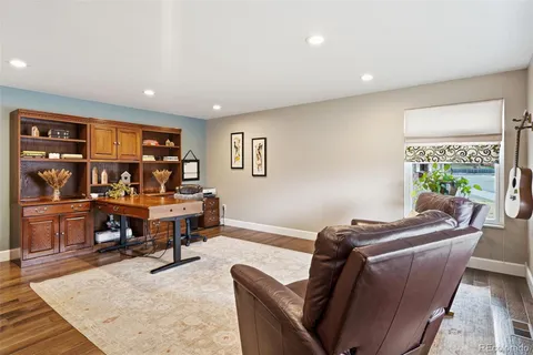 a living room with furniture a rug and a large window