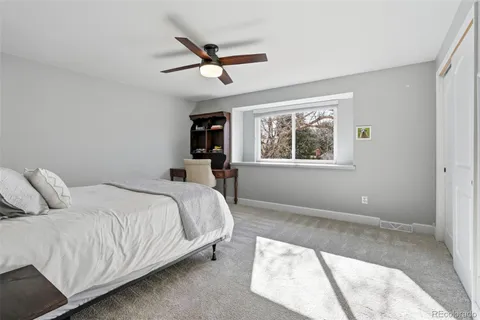 a bedroom with a large bed and window