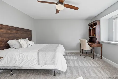 a bedroom with a bed and a chair in it