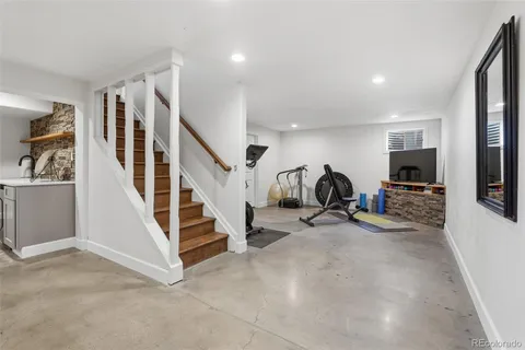 a view of a livingroom with entryway and stairs