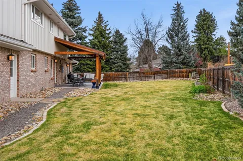 a swimming pool with outdoor seating and yard