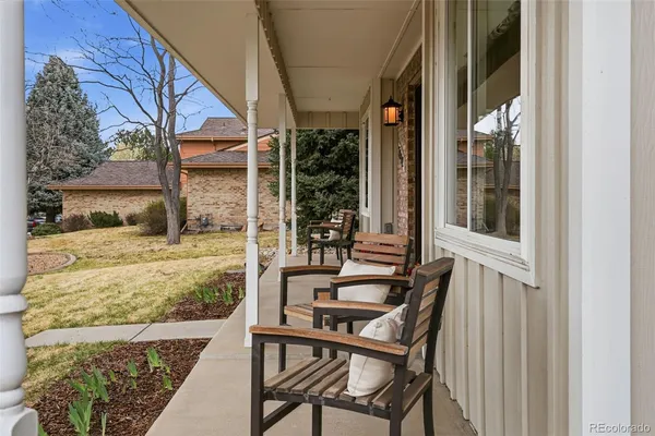 a view of a patio with table and chairs and wooden floor