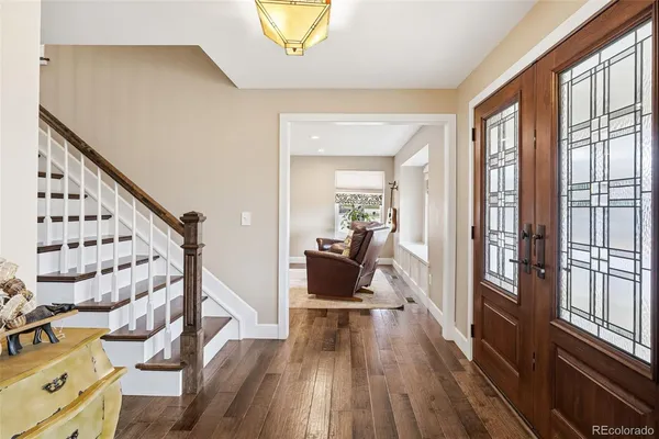 a view of a living room with furniture and wooden floor