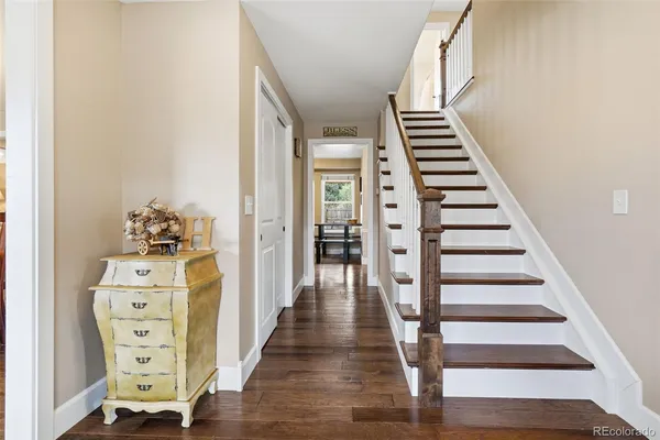 a view of a hallway with wooden floor and entryway